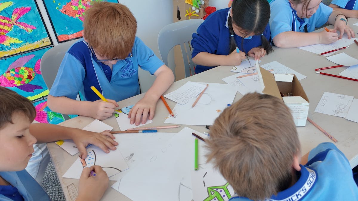 Young students drawing and colouring during a workshop