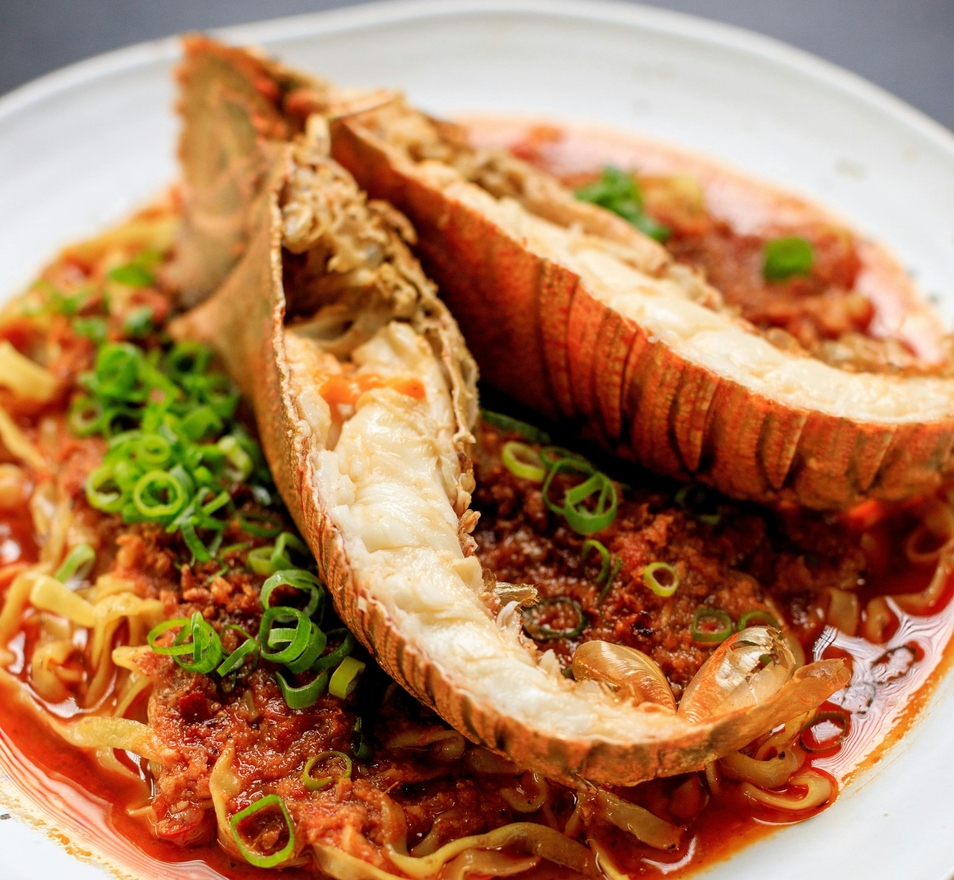 Slipper lobster noodles in shell fish gravy