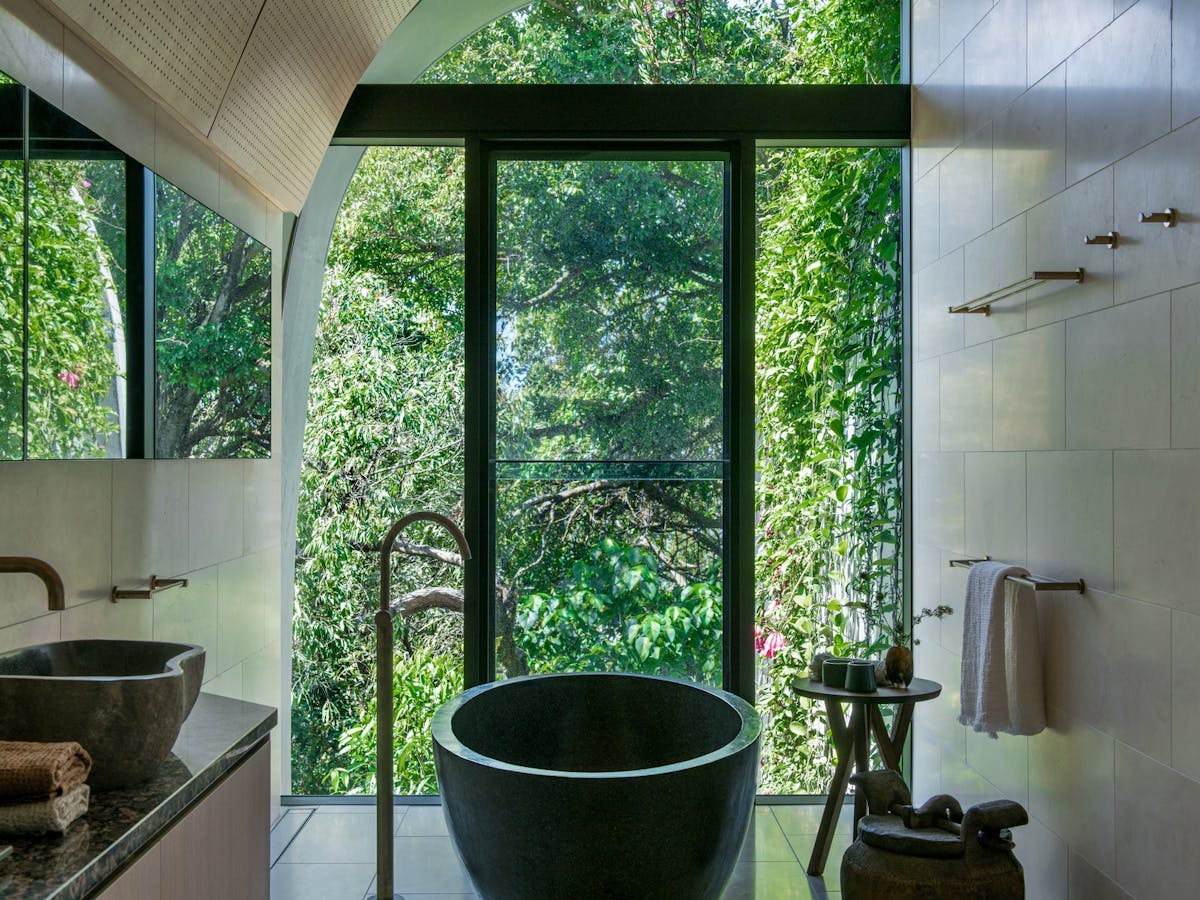 Luxury freestanding bath overlooking lush Noosa National Park at Domic Noosa