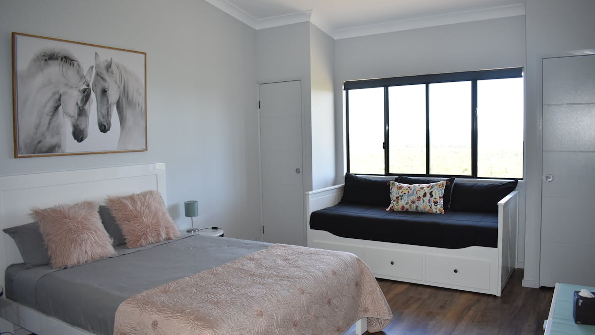 Queen bedroom with daybed and large private bathroom