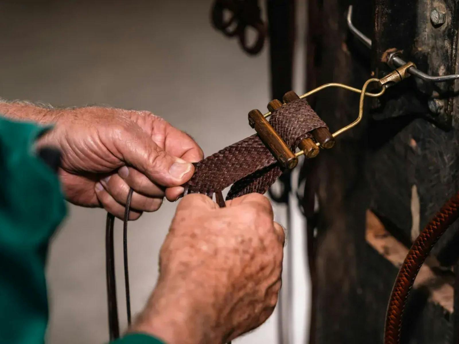 Pair of hands plaiting leather belt