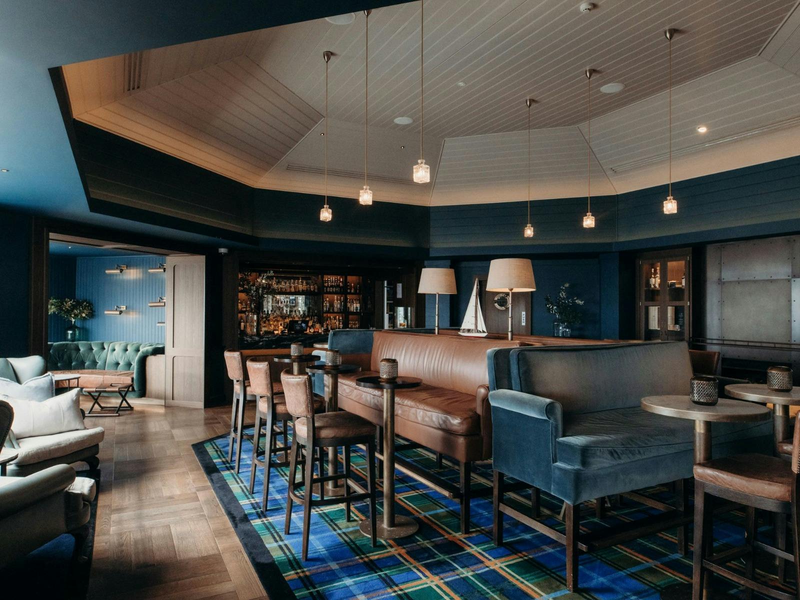 Cosy couches and leather seating with olive green and dark brown tones