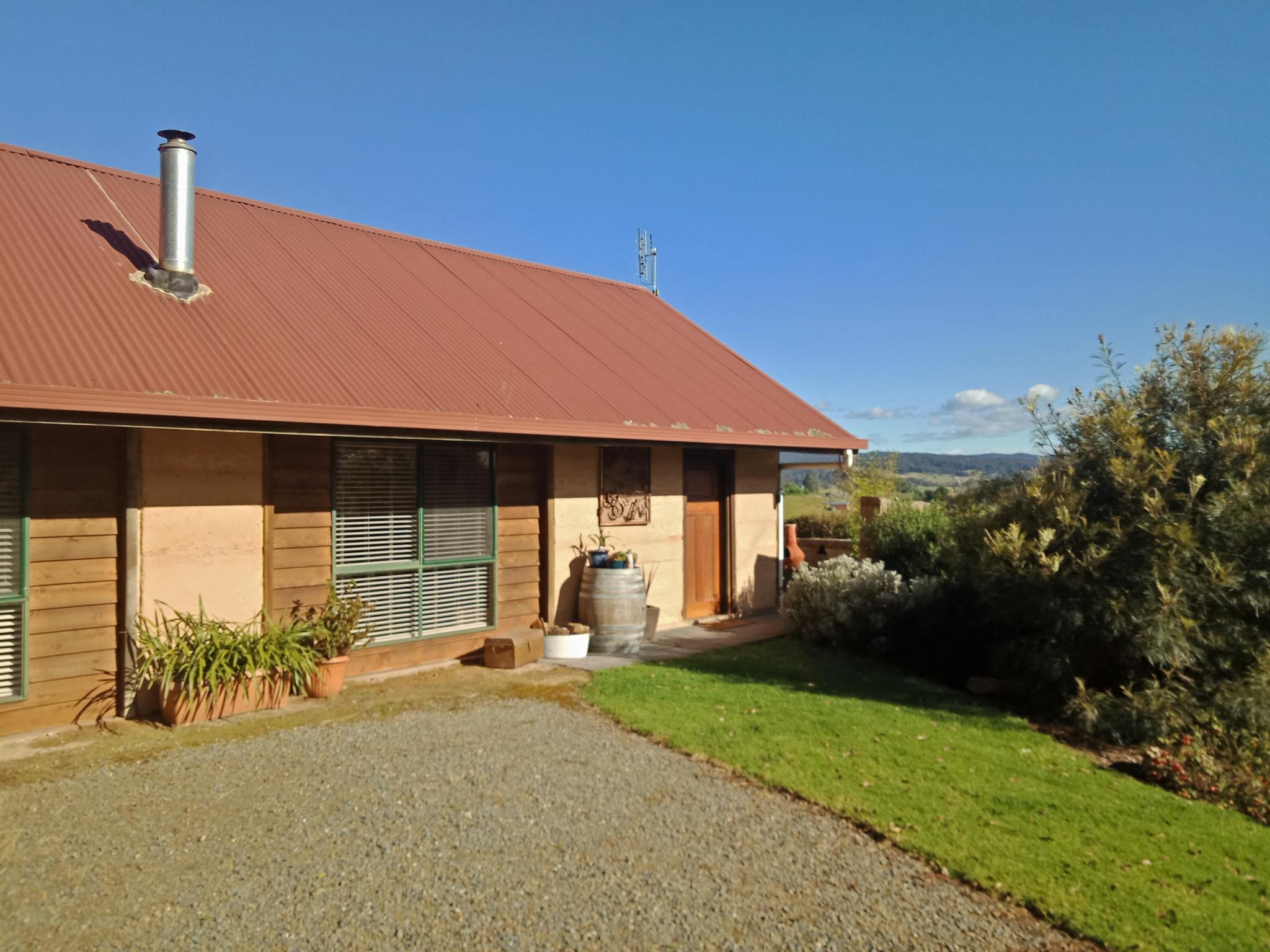 Photo of the building with flat car parking area at the front.