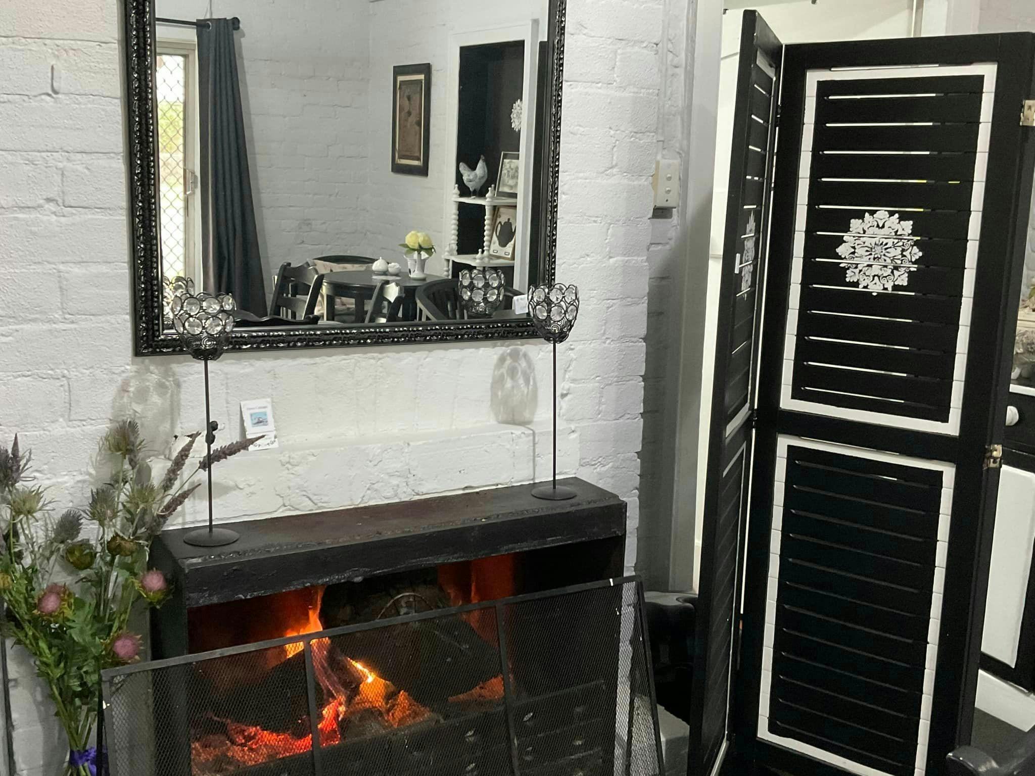 Inside of Thistle café, fire palce, mirror and black and white screen