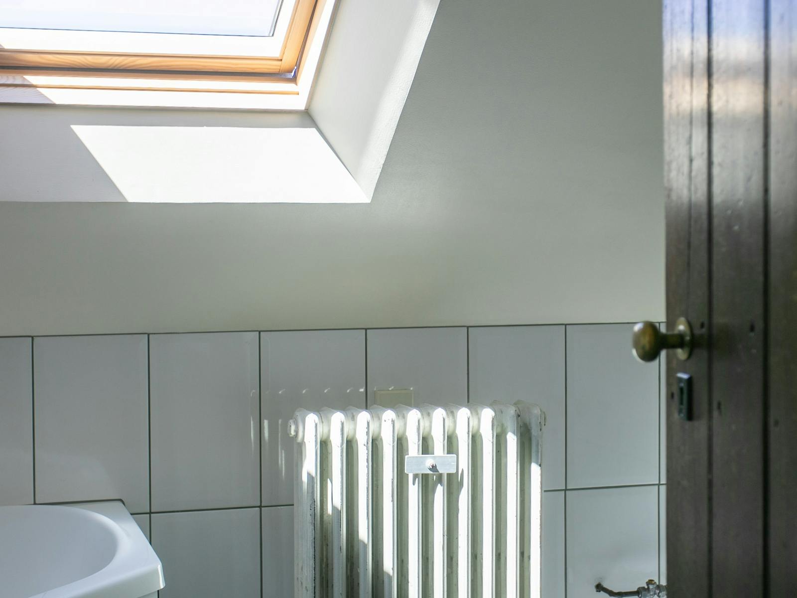 swcond batghroom with skylight, showere nd large corner bath