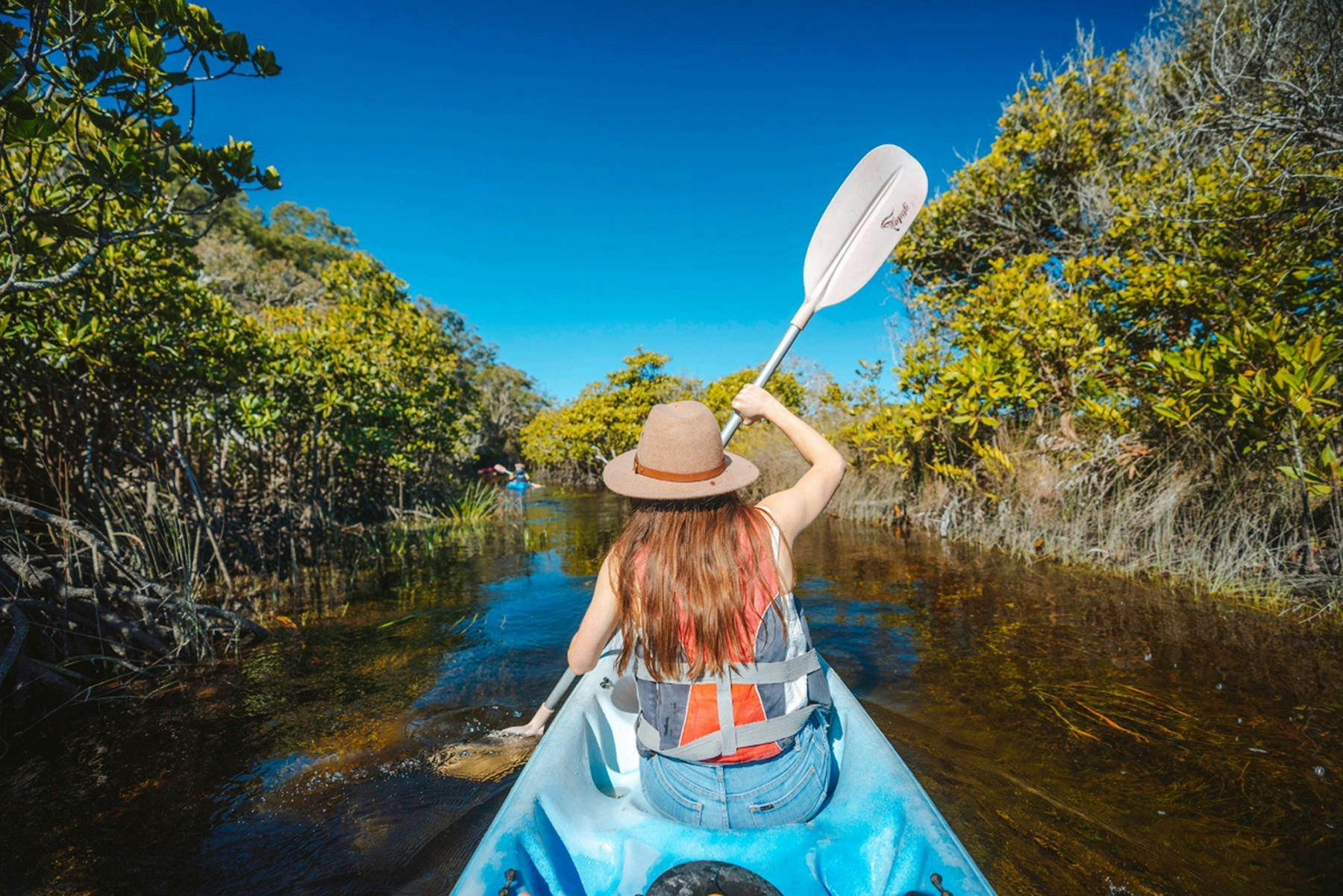 Girl kayaking on K'gari