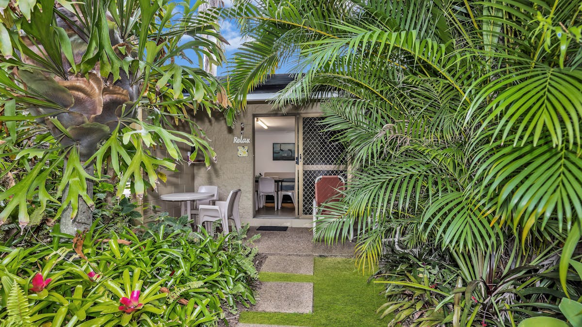 Outside area surrounded by lush gardens