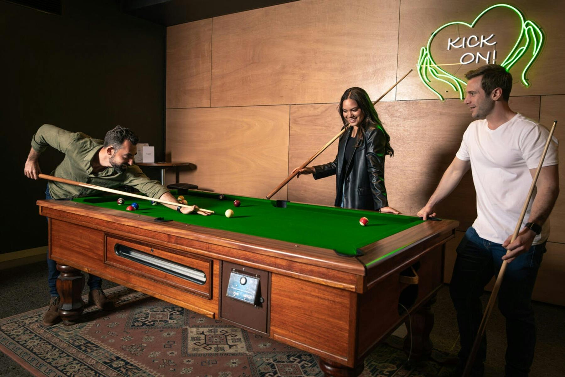 Friends playing pool at The Sherwood