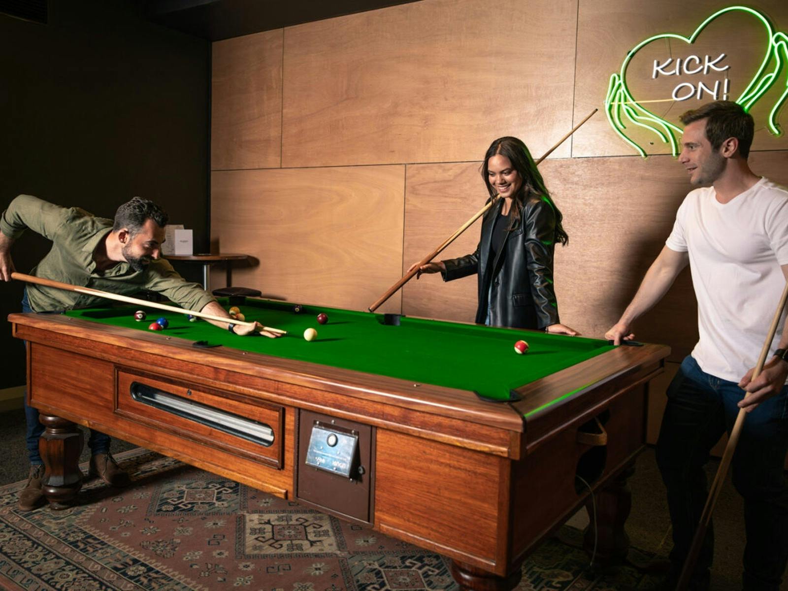 Friends playing pool at The Sherwood