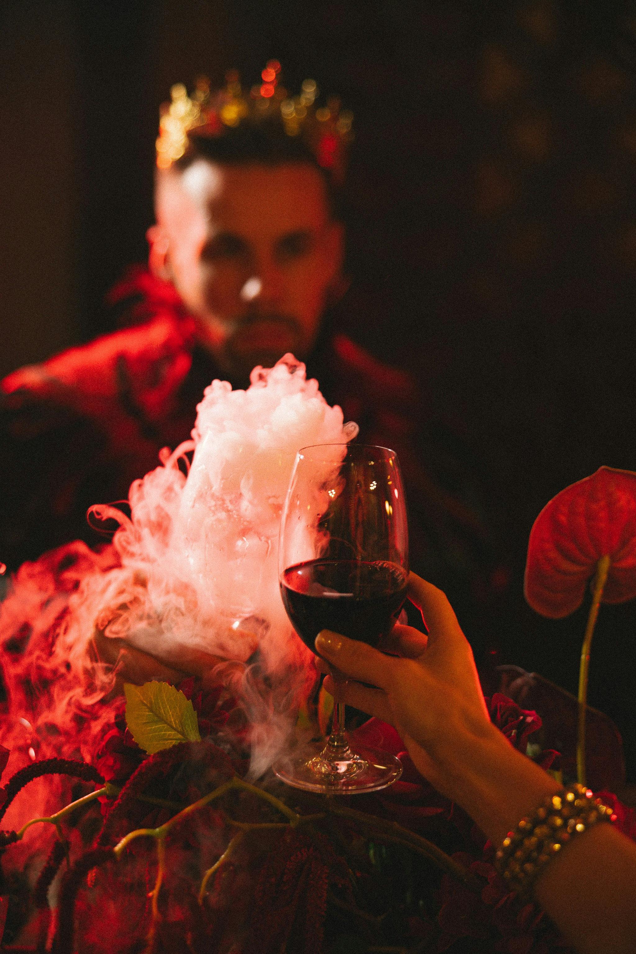 A king character toasting with a smoking goblet