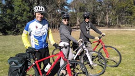 Guide and customers holding bikes.