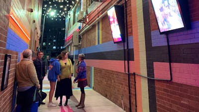 Laneway in Queanbeyan at night with photo-boxes and fairylights