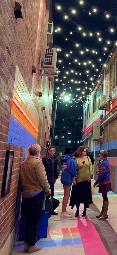 Laneway in Queanbeyan at night with photo-boxes and fairylights