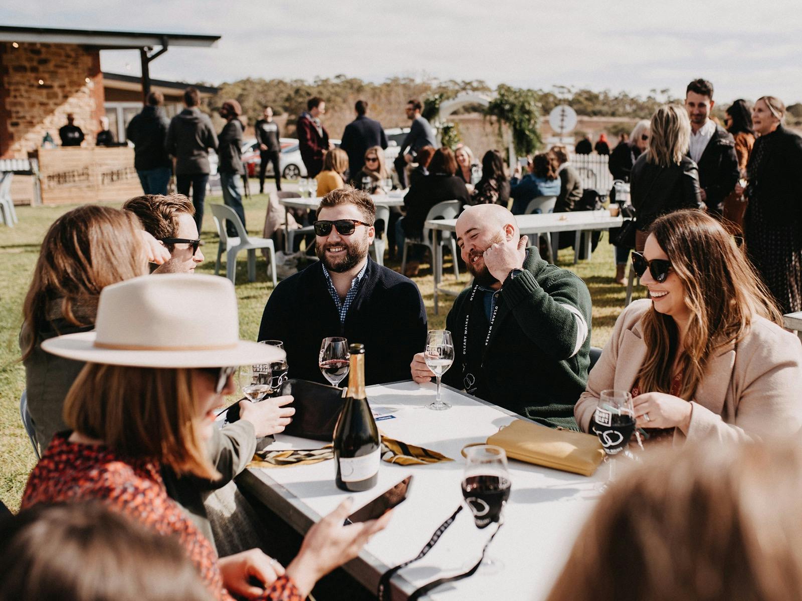Friends relax with a glass of wine at Gourmet Weekend.