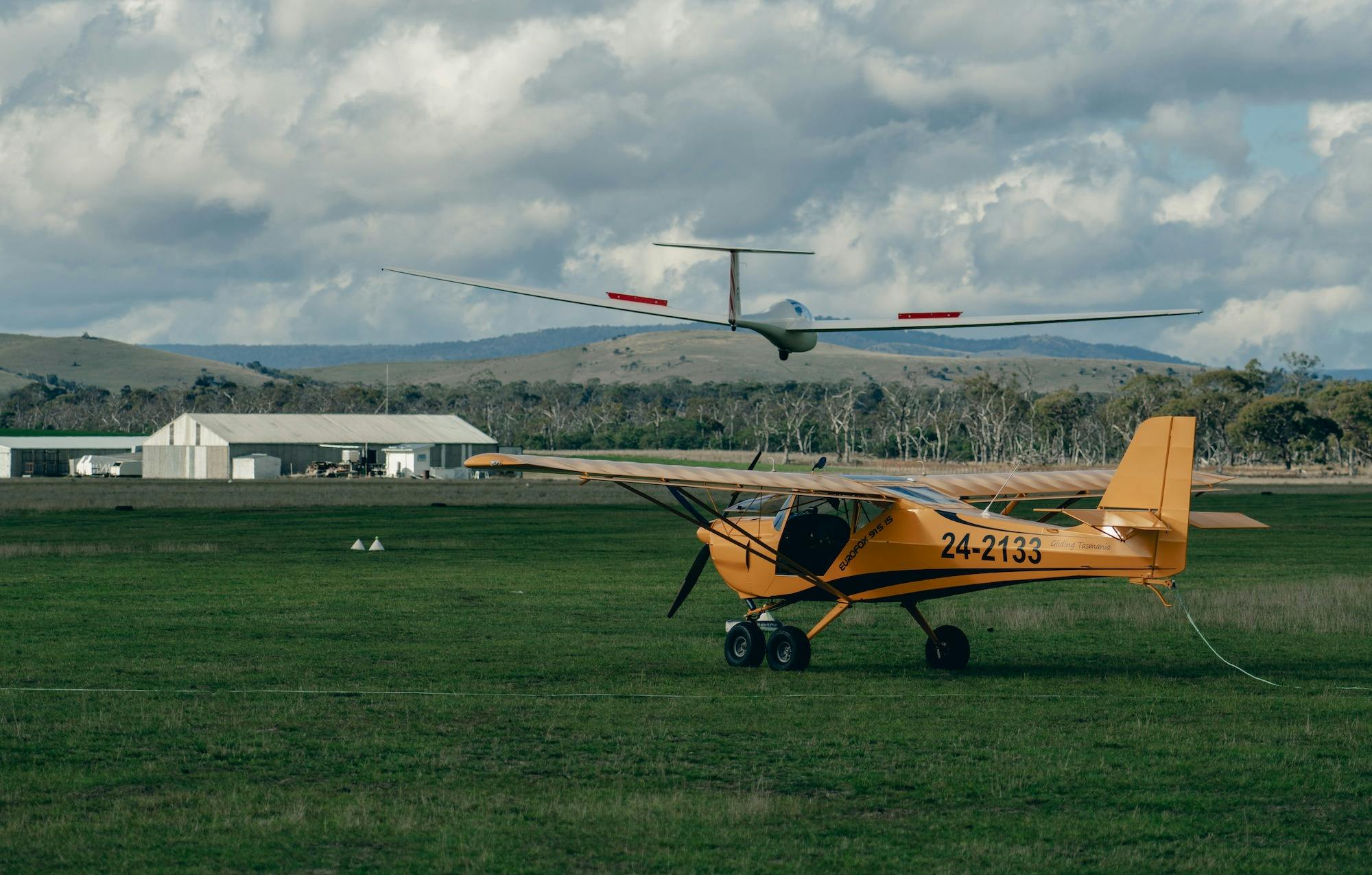 one powered plane, one glider, one hanger