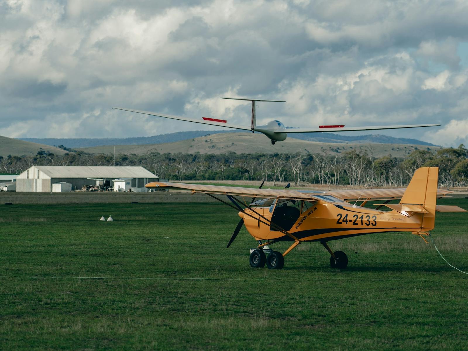 one powered plane, one glider, one hanger