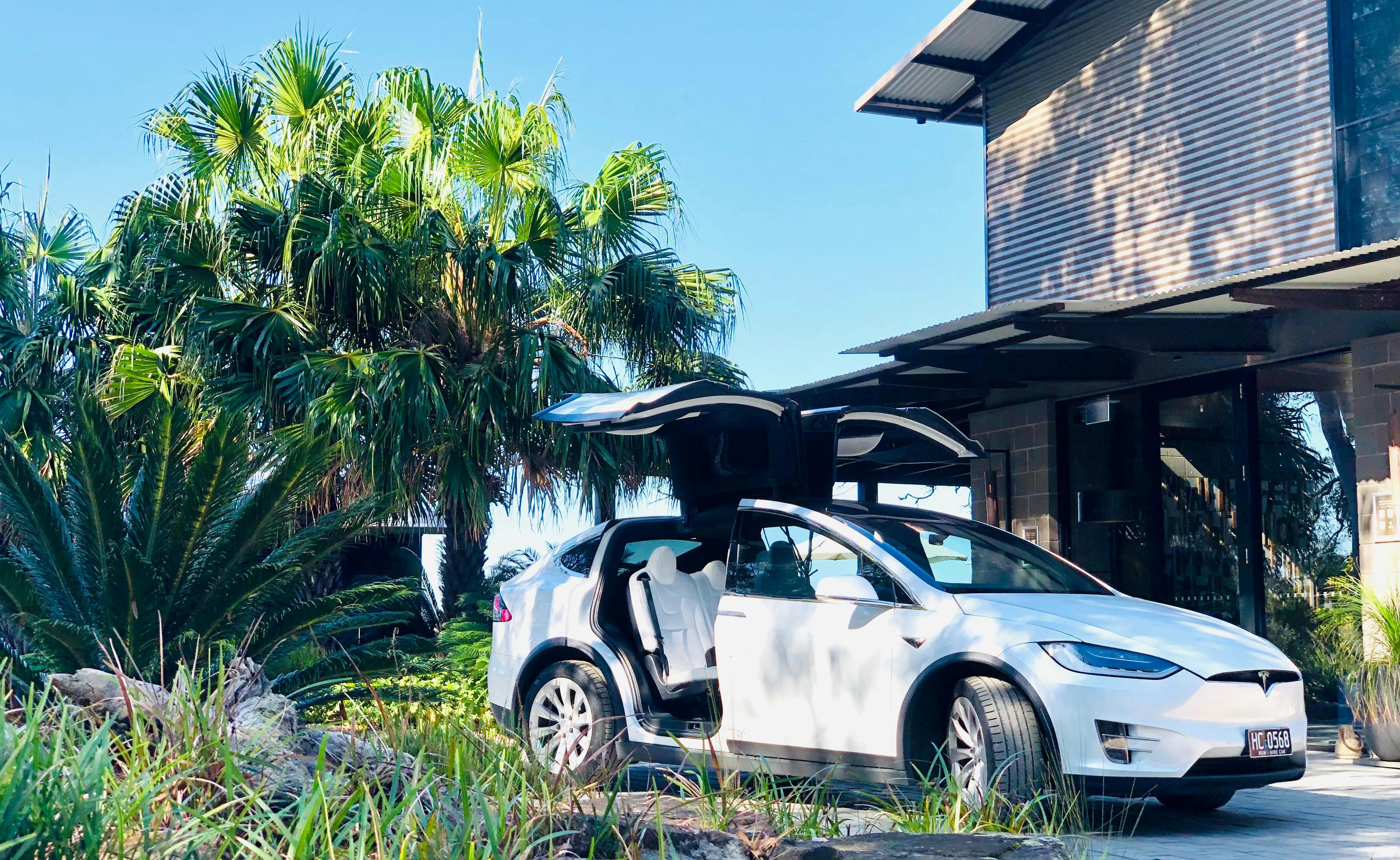 Evoke Tesla Model X doing a pickup from a luxury resort in the Australia bush.