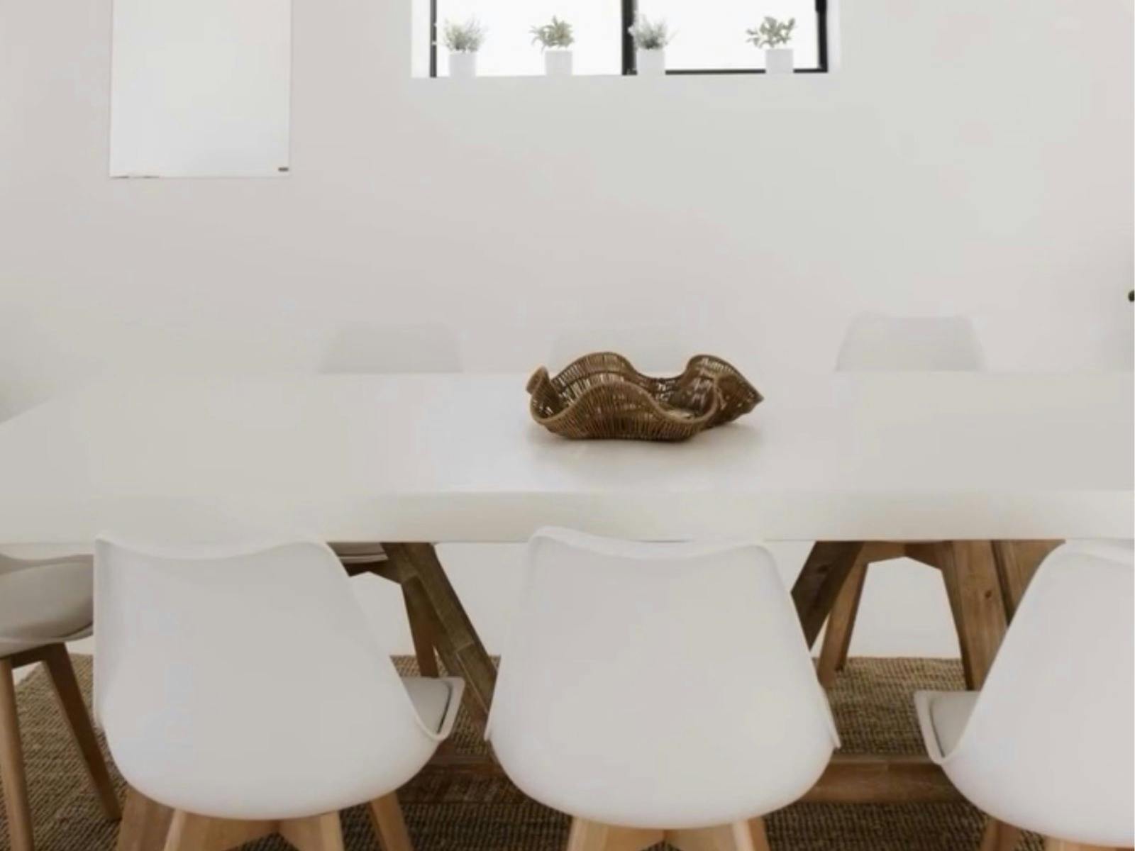 White table and chairs in a light filled space