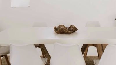 White table and chairs in a light filled space