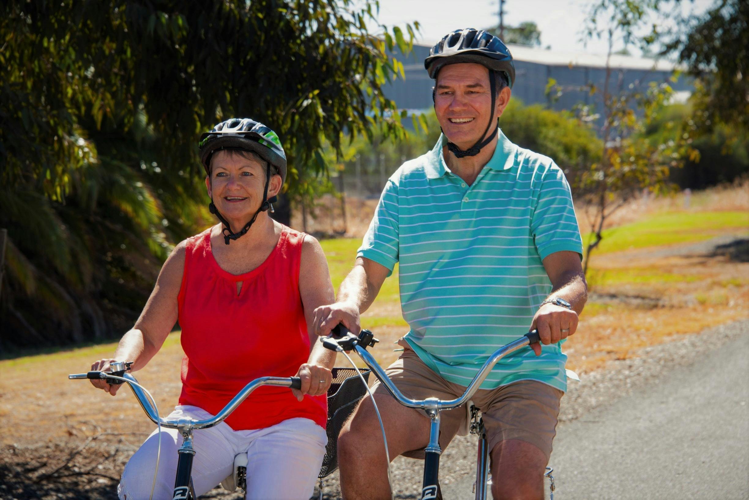 Couple on bikes riding along a sealed trail around the Corowa Wetlands