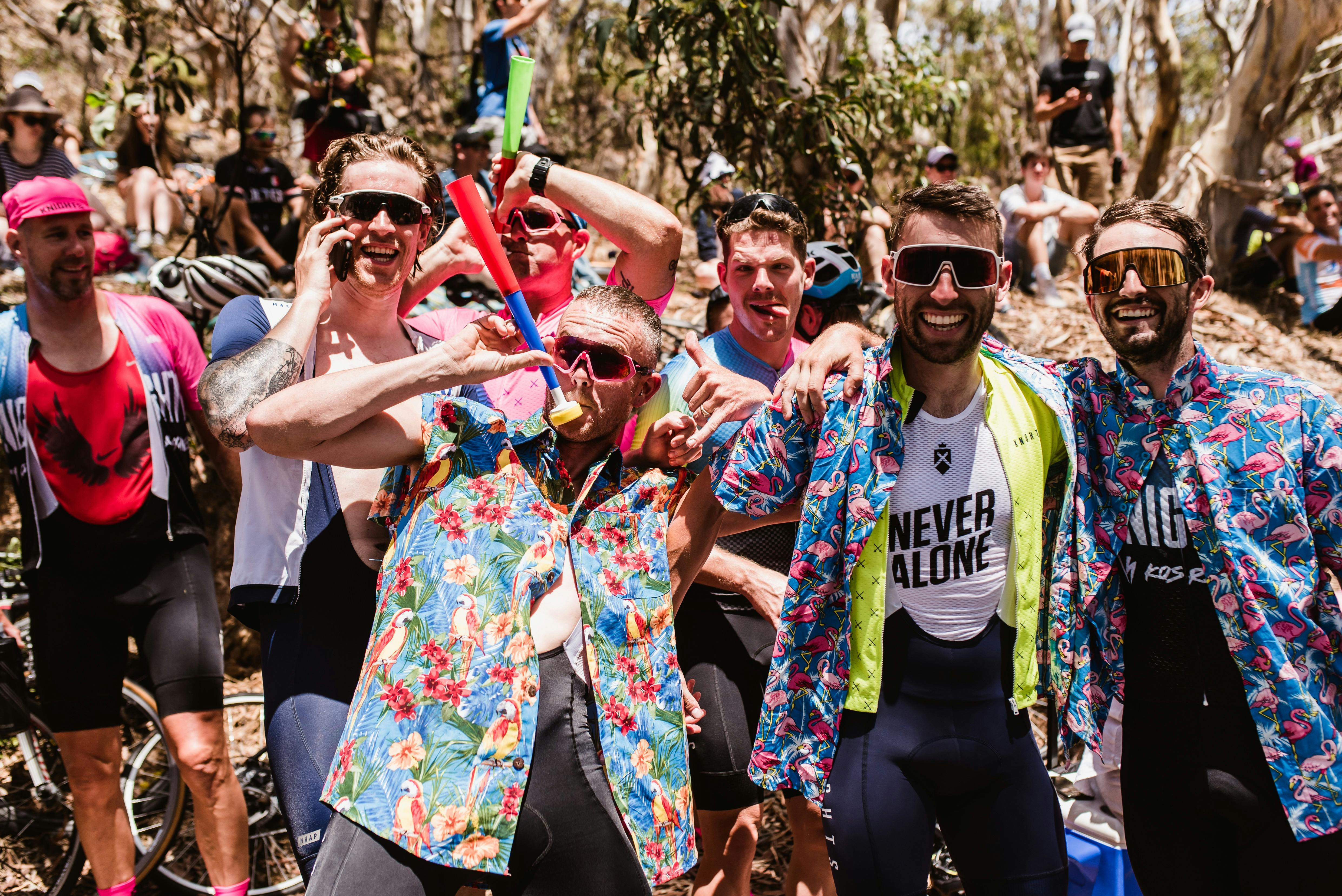 A group of spectators for a Santos Tour Down Under cycling event smiling and posing for a photo.
