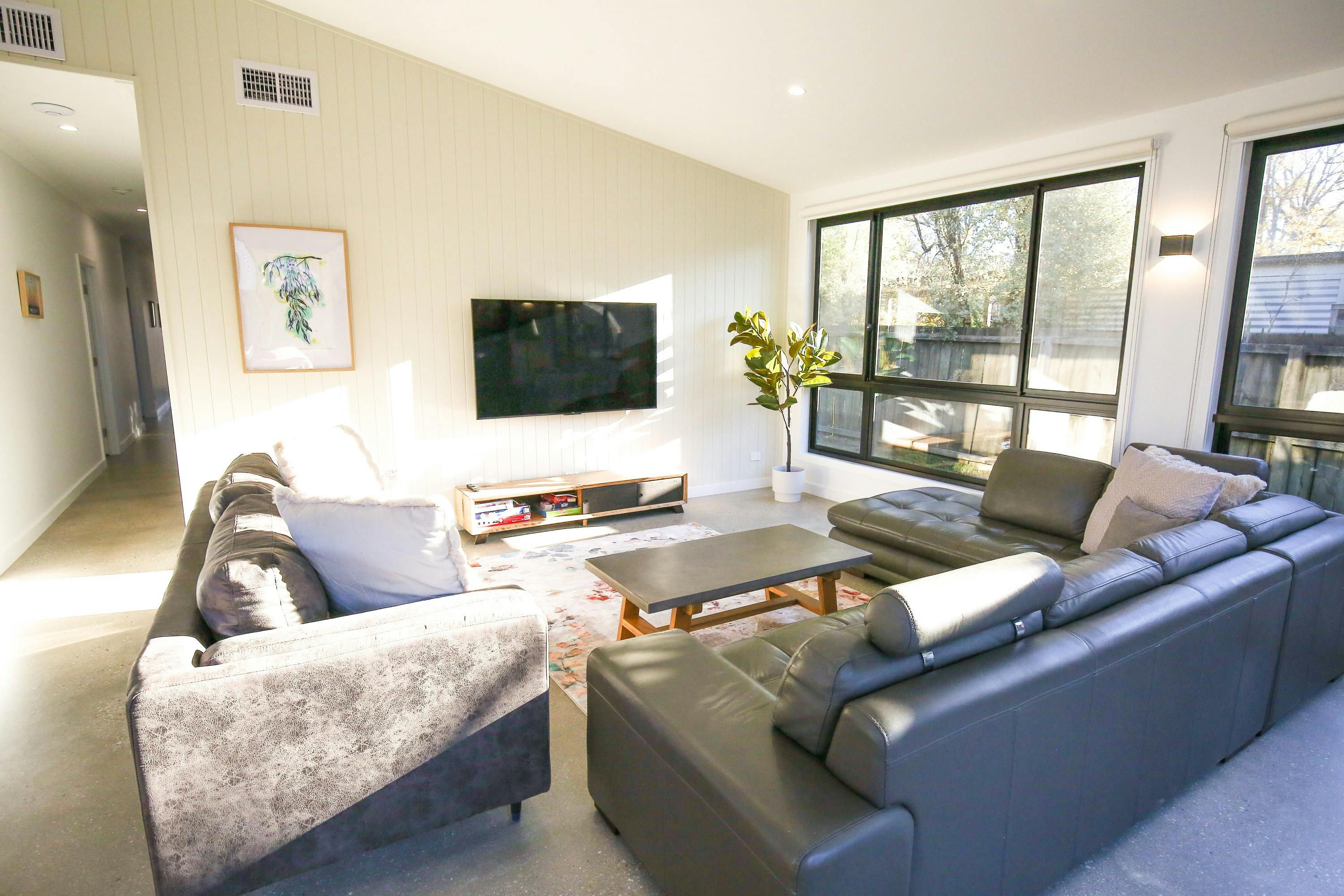 Lounge area with television at family Group accommodation Bright Victoria