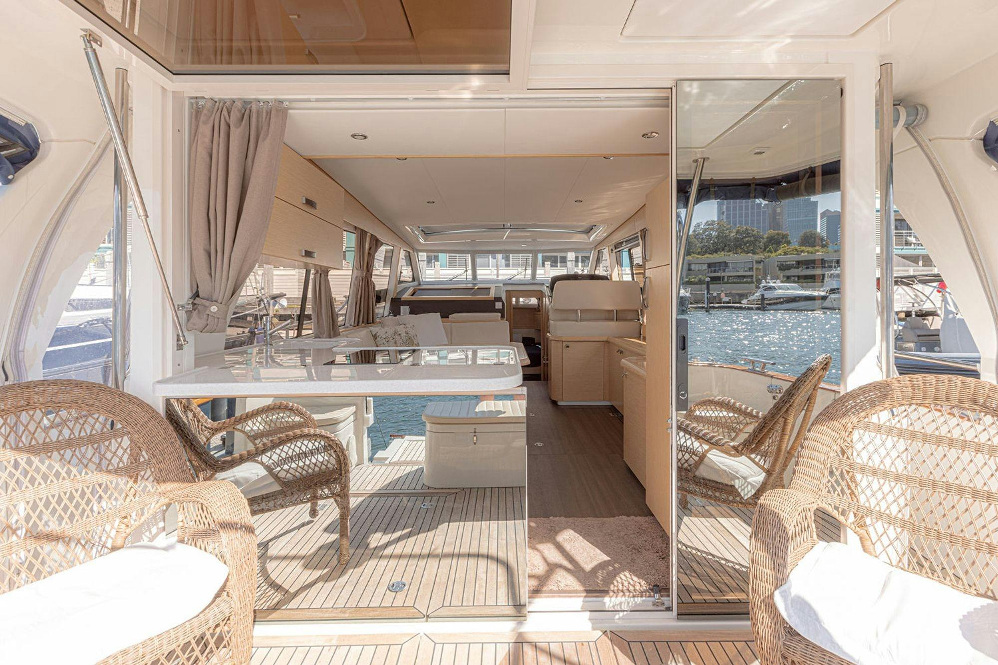 EV Arcadia open deck and saloon interior with wicker chairs and harbour views Sydney