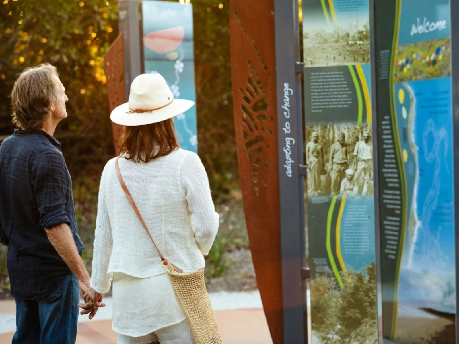 two people backs rowards the camera reading signage