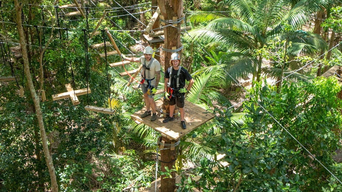 2 guests on a platform on black course
