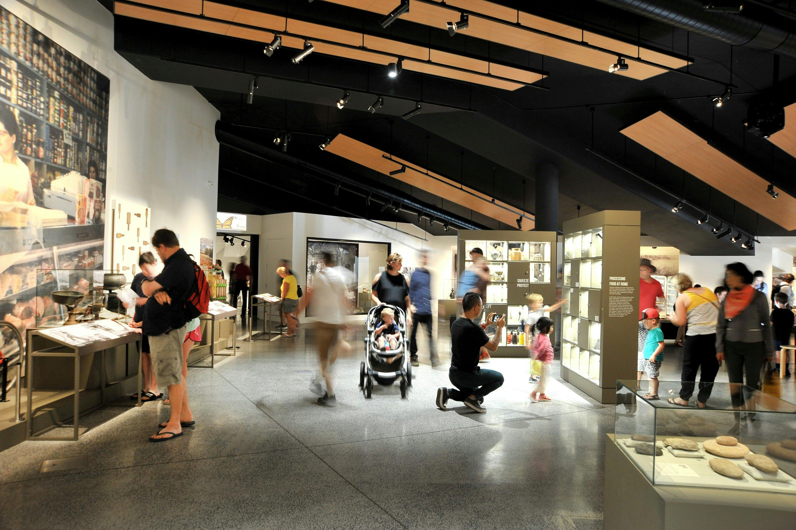 People looking at the past exhibition 'Paddock to Plate' at Orange Regional Museum