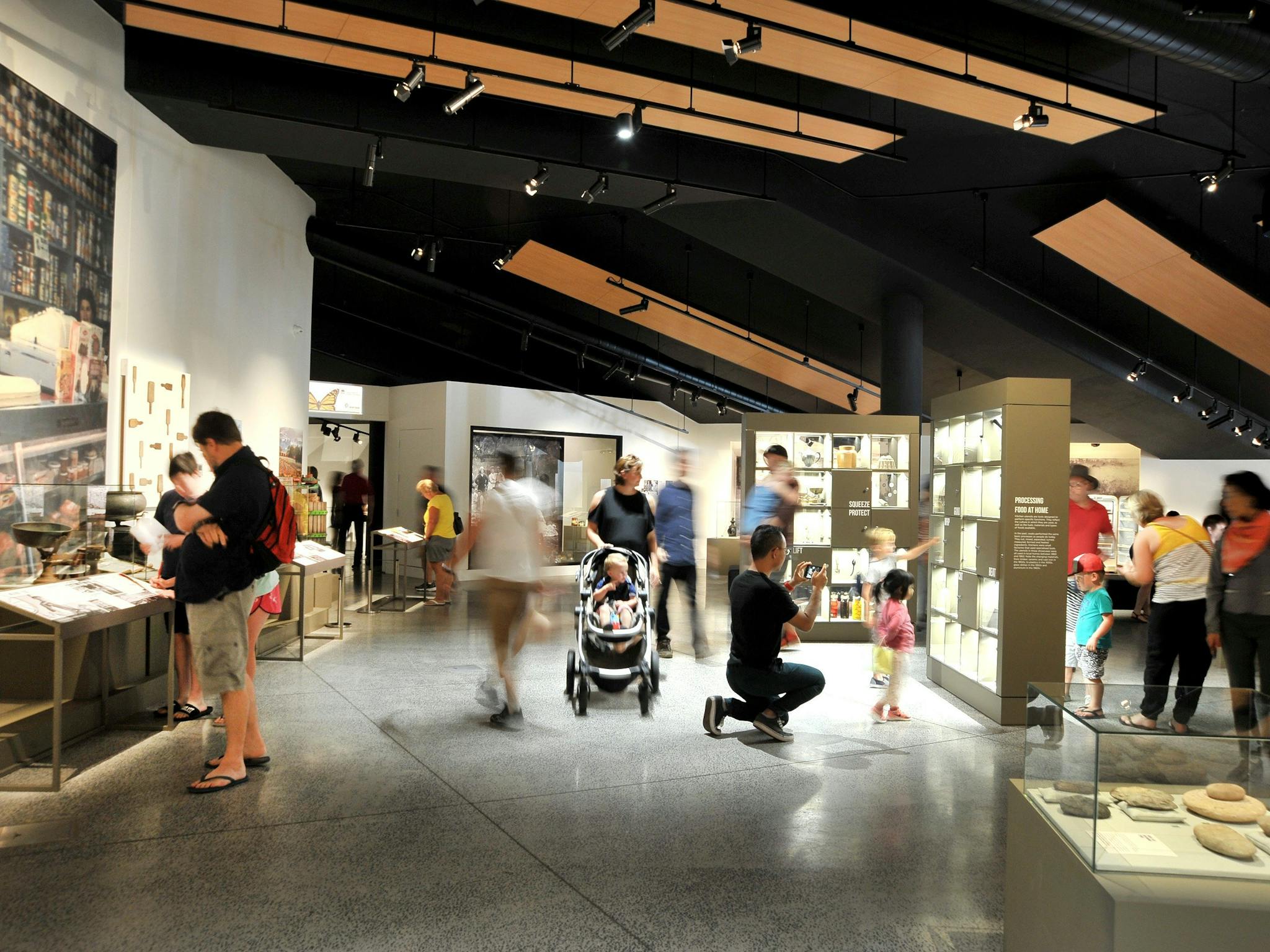 People looking at the past exhibition 'Paddock to Plate' at Orange Regional Museum