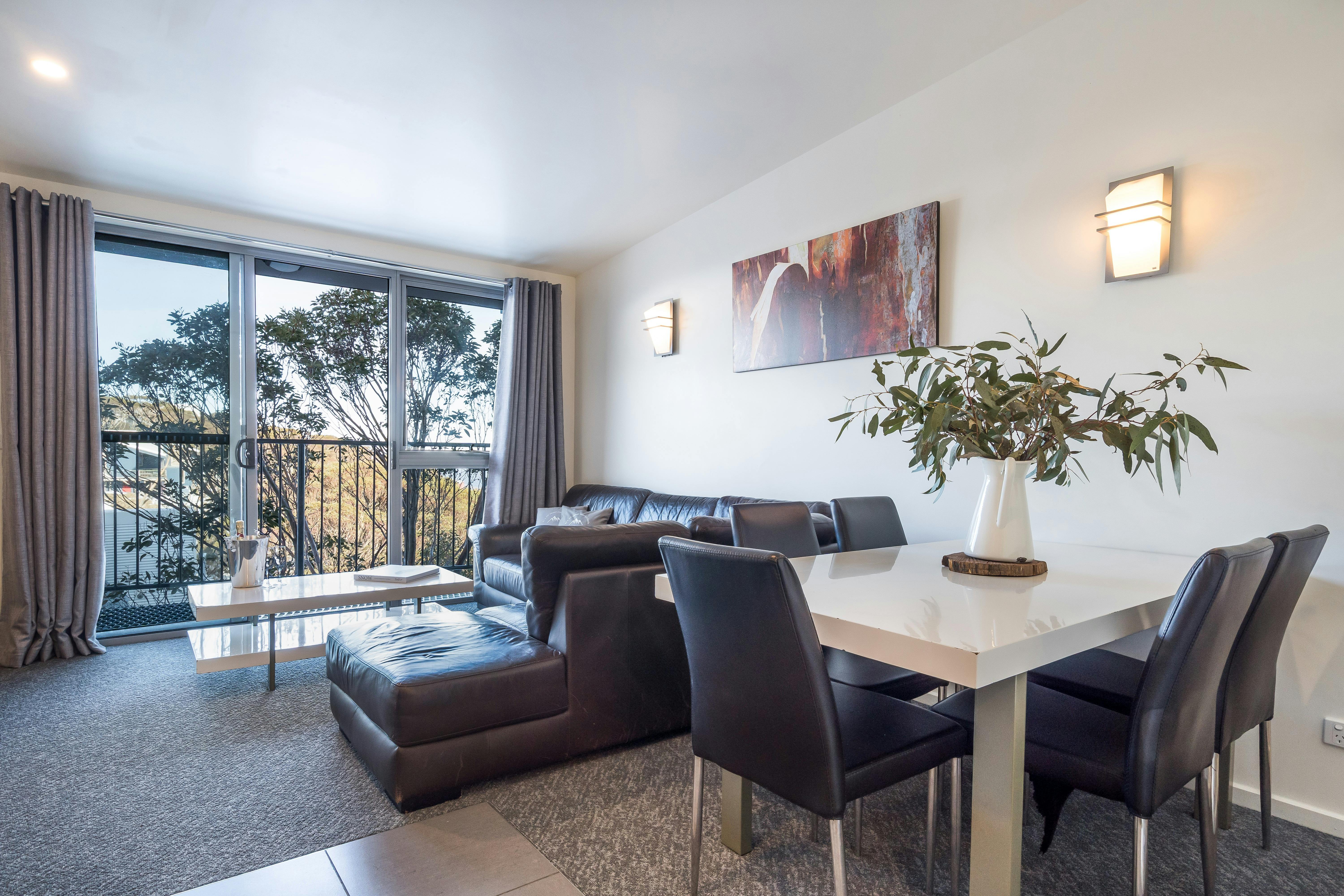 Dining table with 5 seats, L shaped lounge, coffee table and smart TV. Upstairs in 2 bedroom layout.