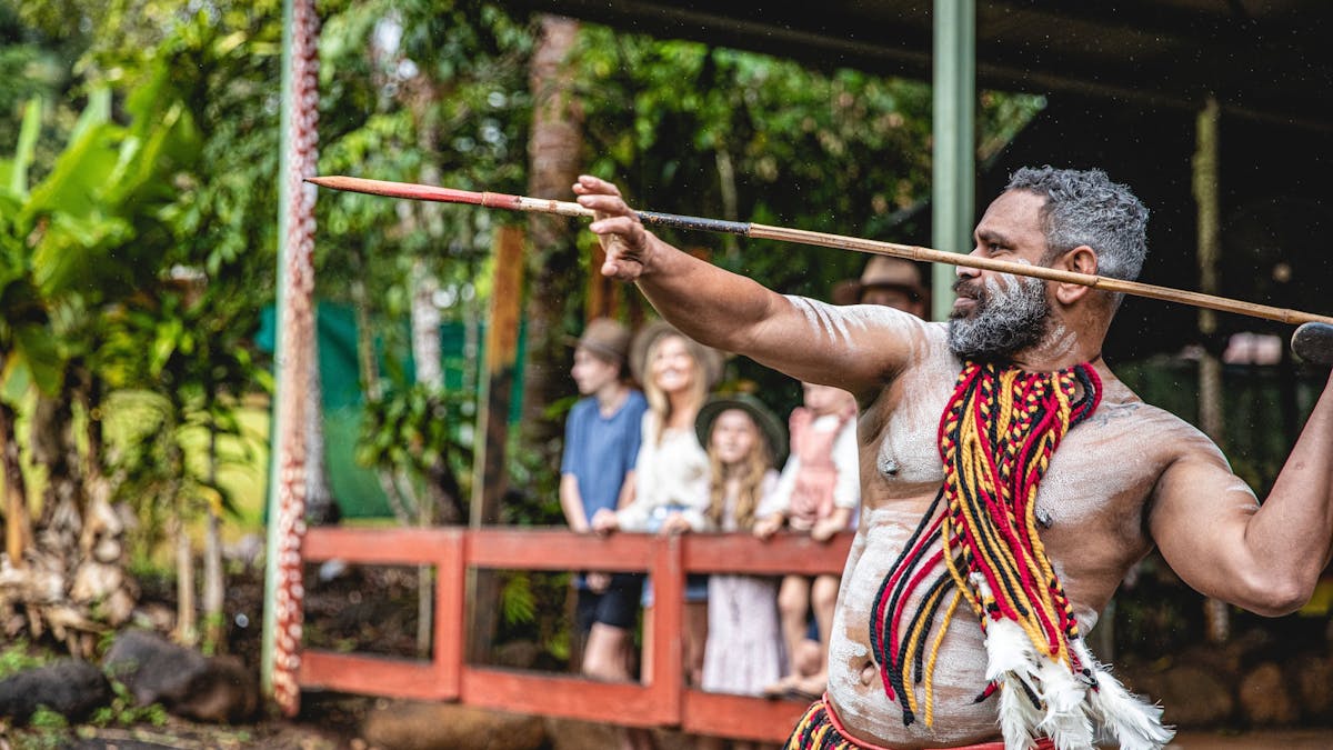 Pamagirri Aboriginal guide showcasing the traditional spear throwing in front of a group of visitors