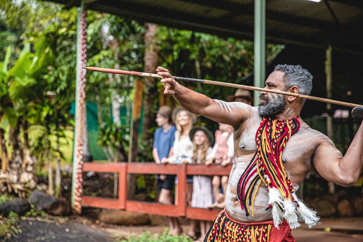 Pamagirri Aboriginal guide showcasing the traditional spear throwing in front of a group of visitors