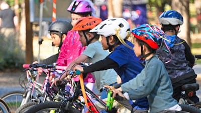 A group of bys with bicycles