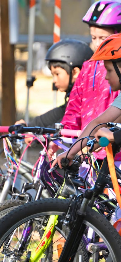 A group of bys with bicycles
