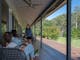 Guests enjoying wine on the veranda of the Hume House Merrijig