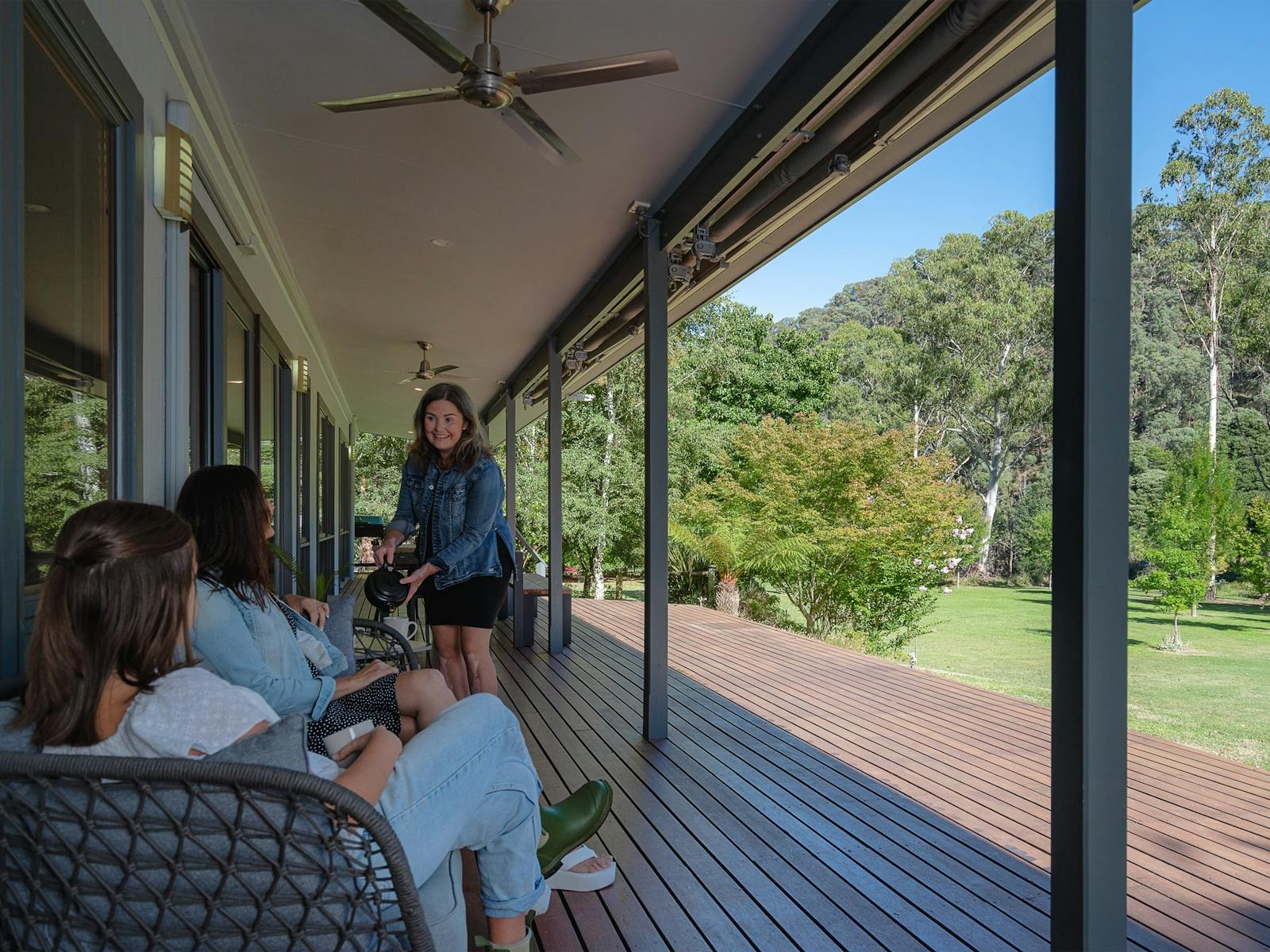 Guests enjoying wine on the veranda of the Hume House Merrijig