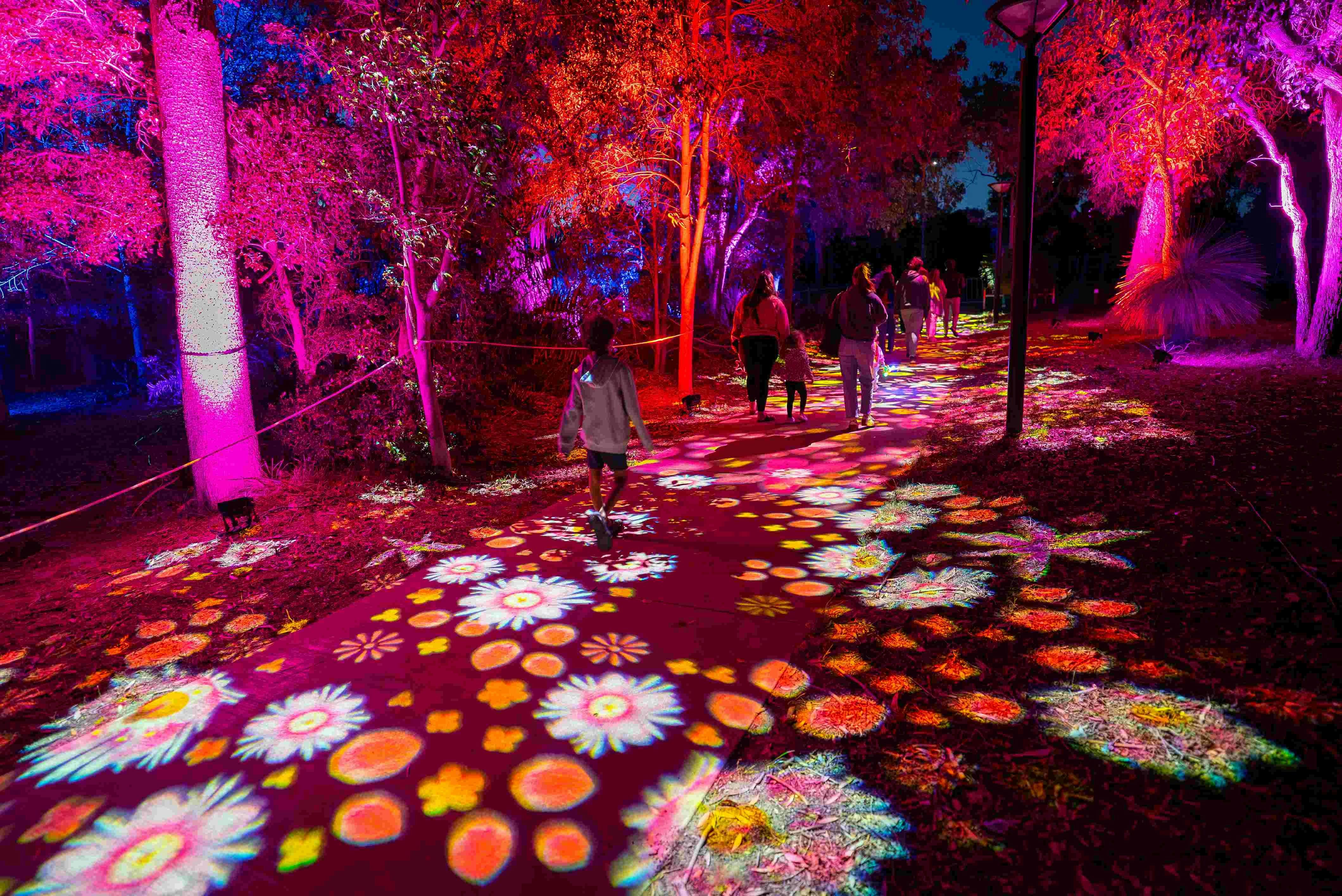 People walking through interactive lights
