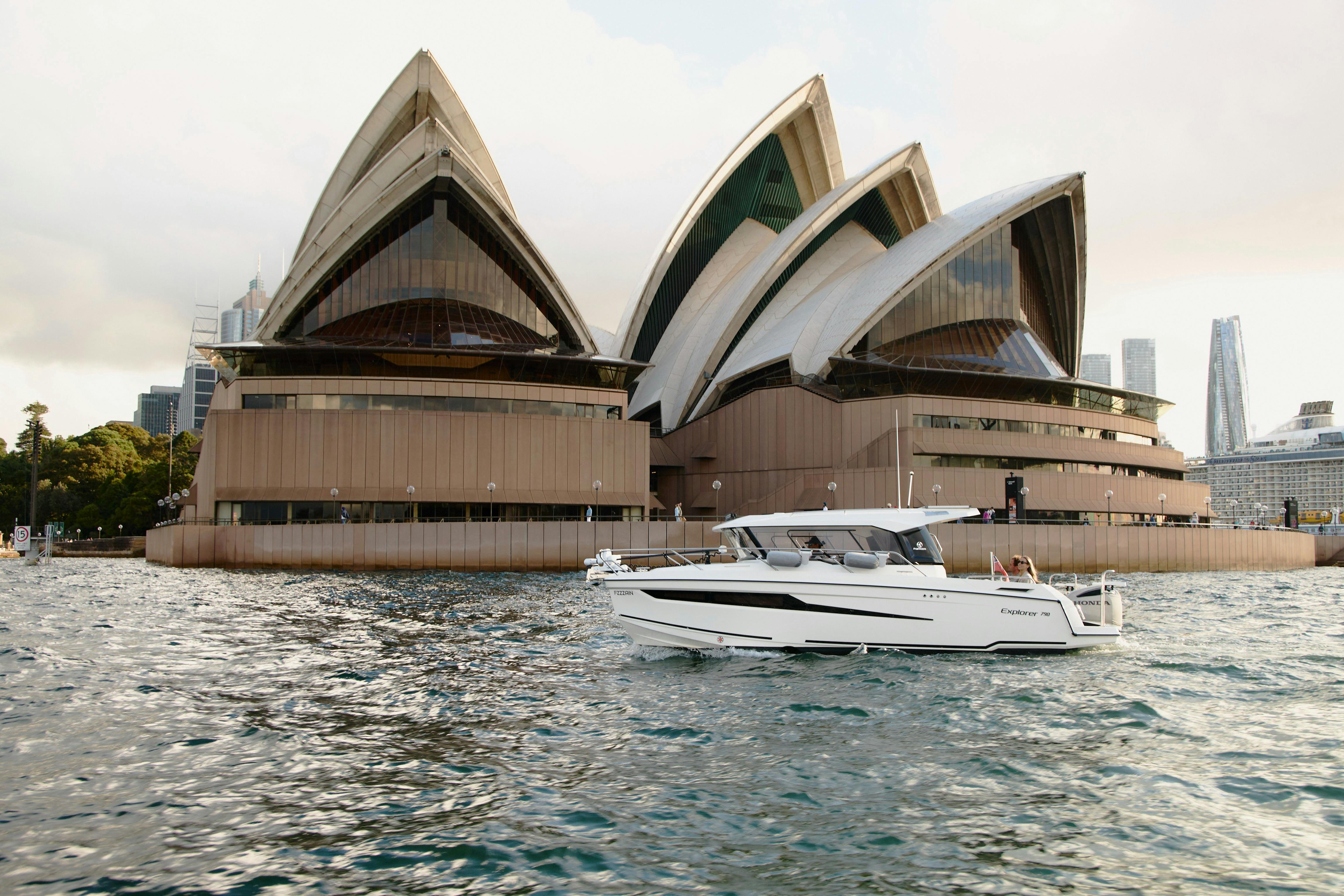 MV Explorer luxury cruise boat on Sydney Harbour with Harbour Bridge in the background.