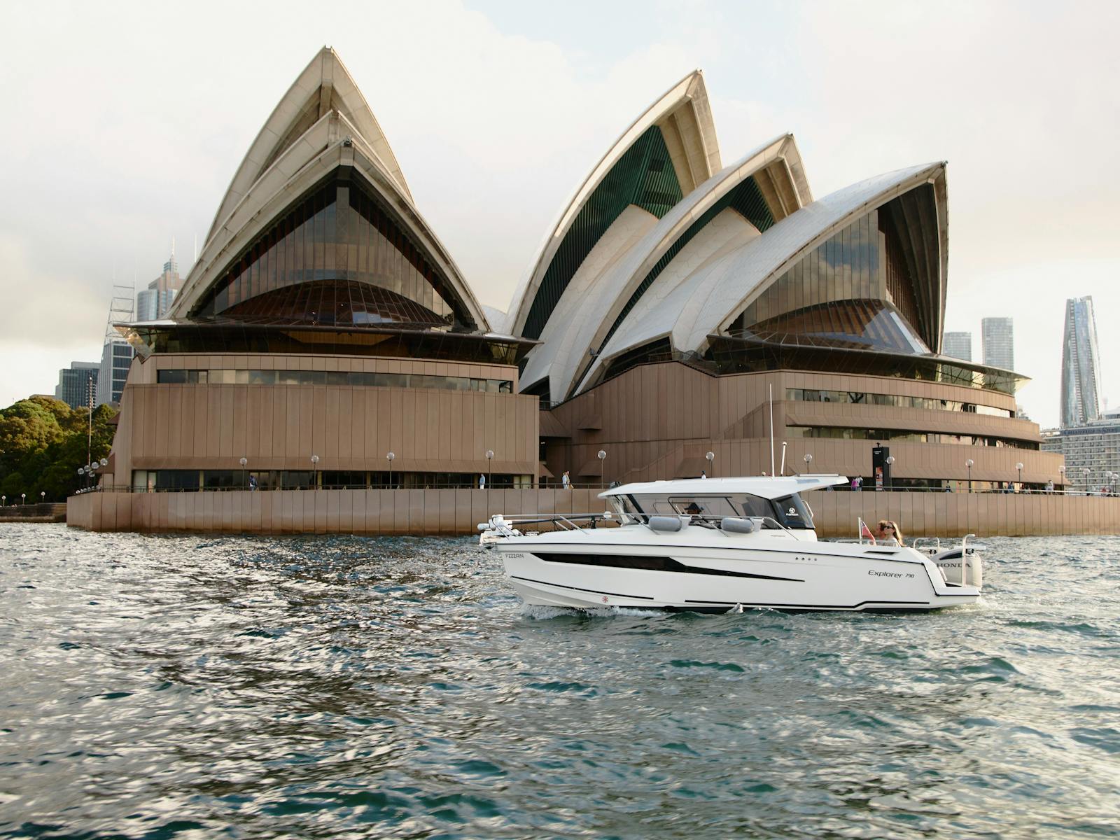 MV Explorer luxury cruise boat on Sydney Harbour with Harbour Bridge in the background.