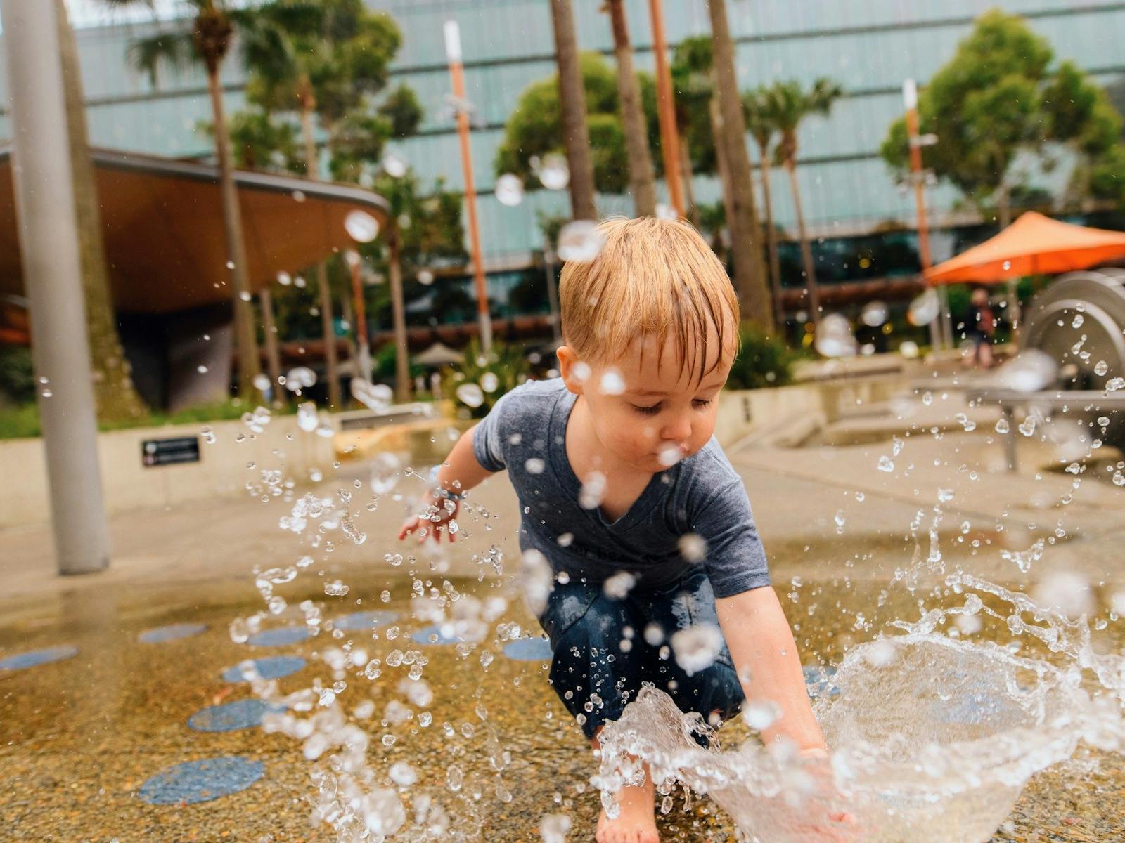 Young boy having a fun day out at The Playground, Darling Quarter