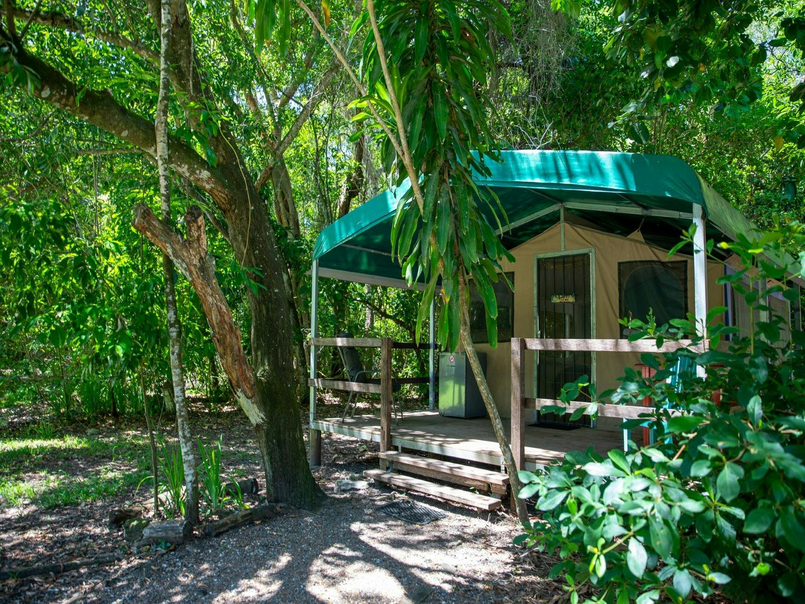 Front view of safari tent showing veranda, set amongst the garden Front view of safari tent showing veranda, set amongst the garden