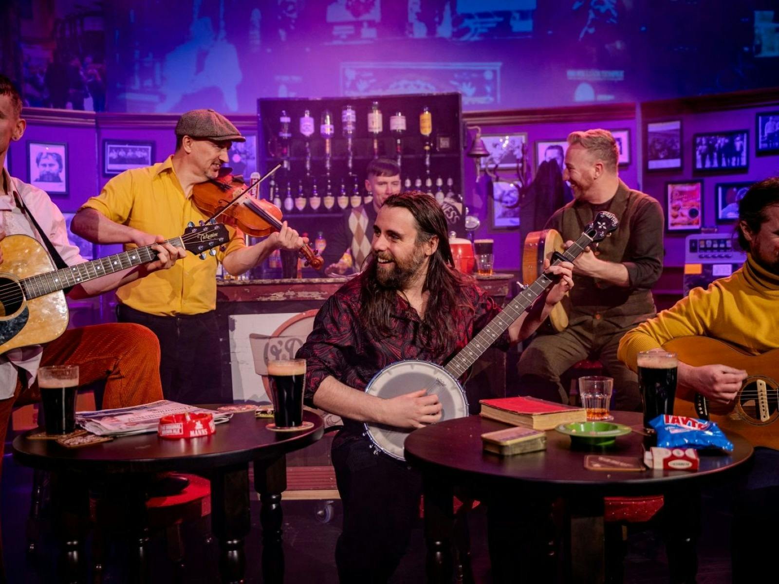 Five men playing instruments in a bar