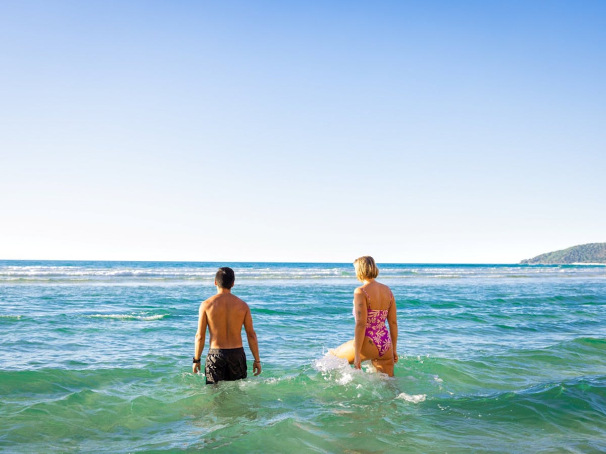 People swimming in the ocean at Double Island point