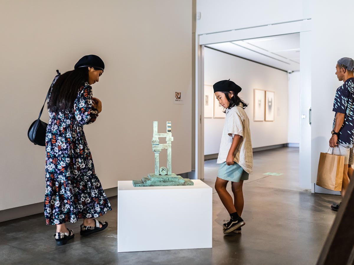 Family viewing sculpture from 'Marc Clark: A life in art' exhibition