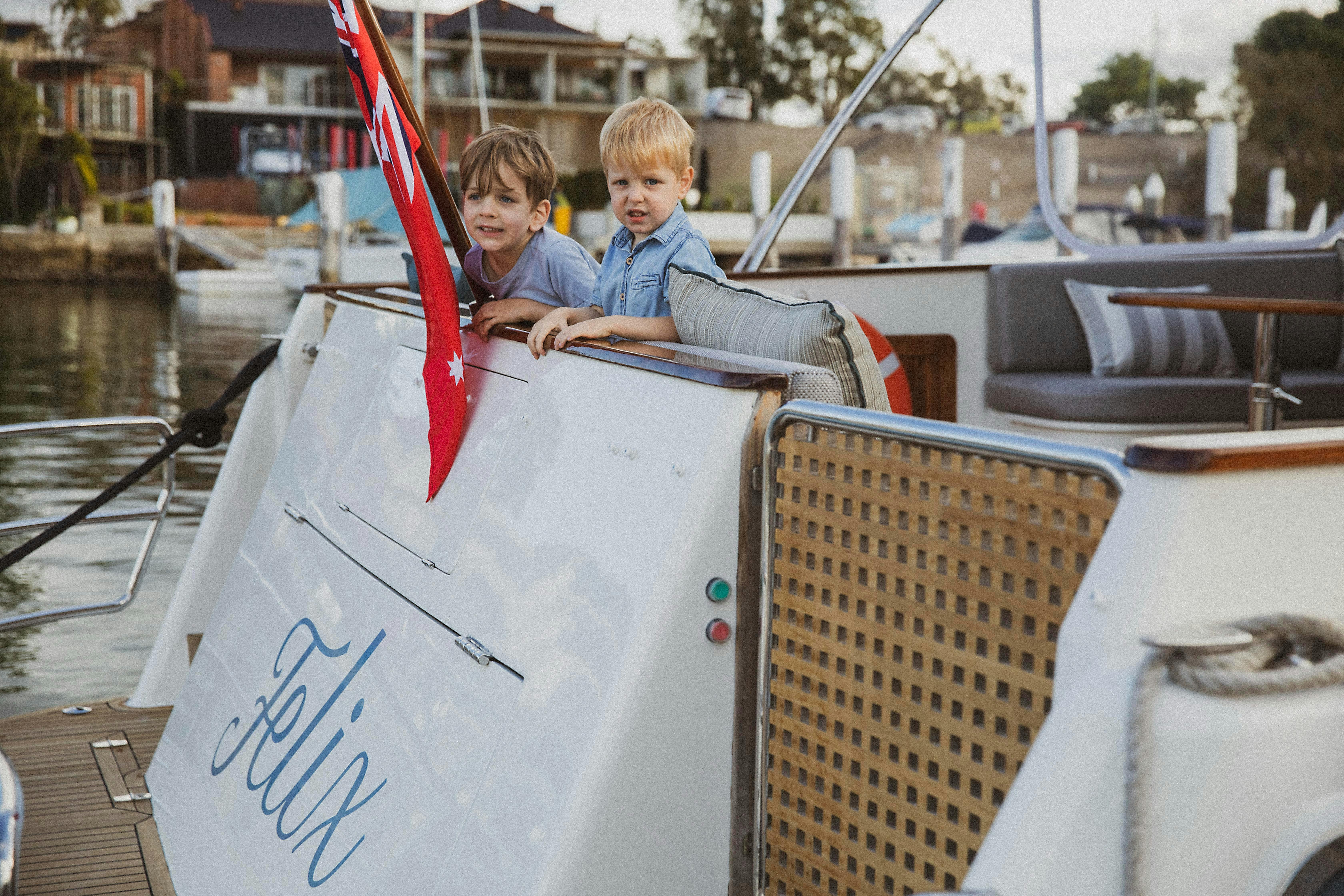 two kids on the back of a boat