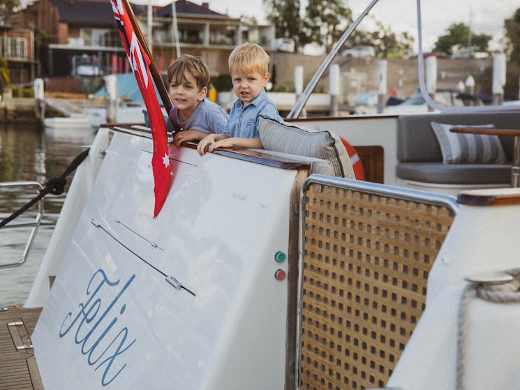 two kids on the back of a boat
