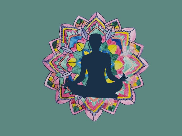 Painted mandala with a silhouette of a seated yoga pose.