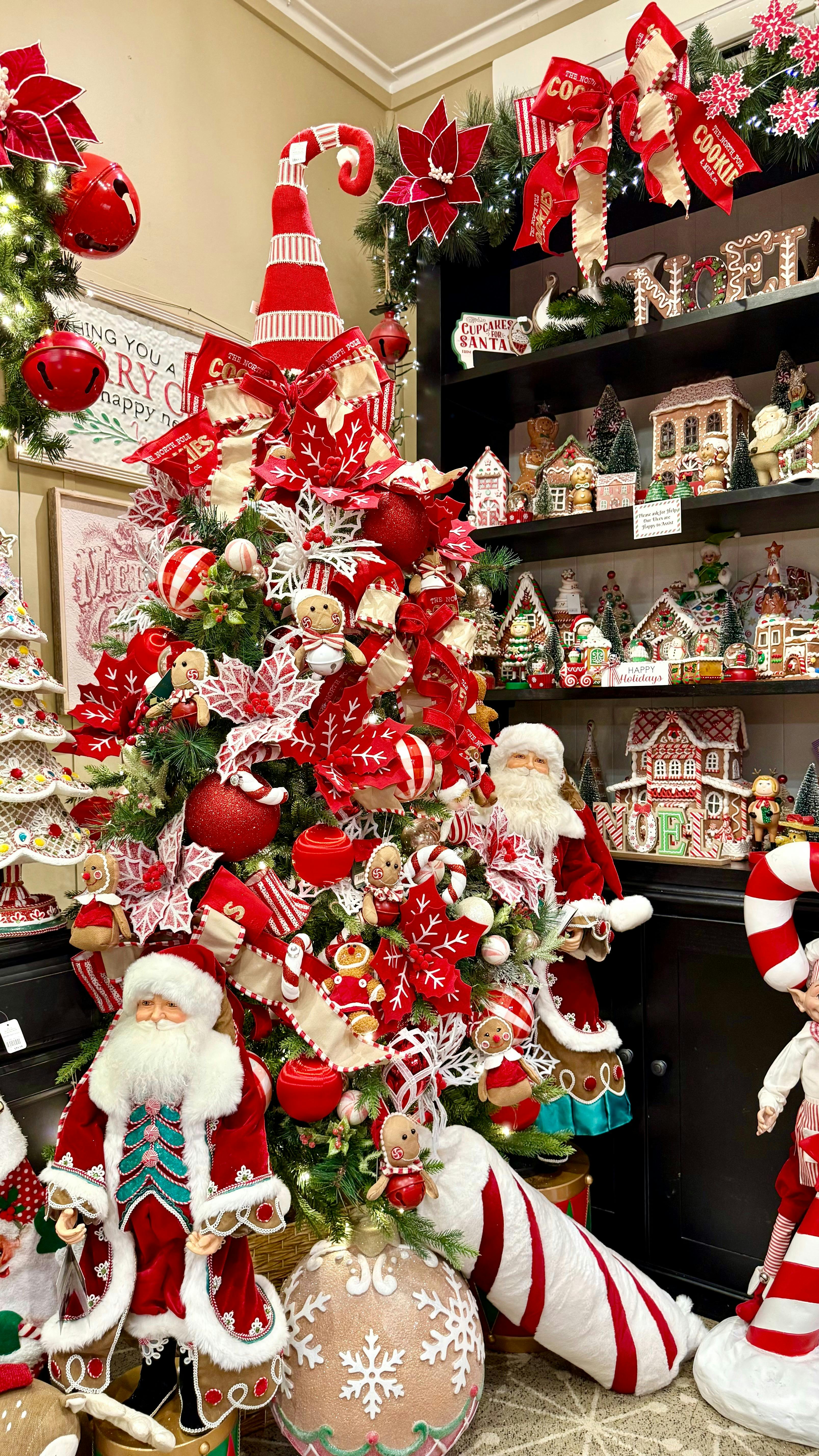 A red and white candy cane themed tree from within the store